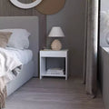 This Anegam Nightstand with Open Storage, White combines contemporary style with smart storage solutions, creating a space saving furniture.